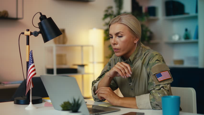 U.S. female military officer working on laptop and using phone for communication - Powered by Shutterstock - Get 15% off with code: PIKWIZARD15