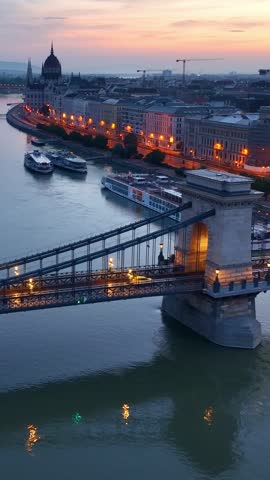 drone vertical video of Hungarian capital of Budapest aerial view at night, aerial view of Danube river with evening illumination, Houses of Parliament in Budapest with night illumination. 