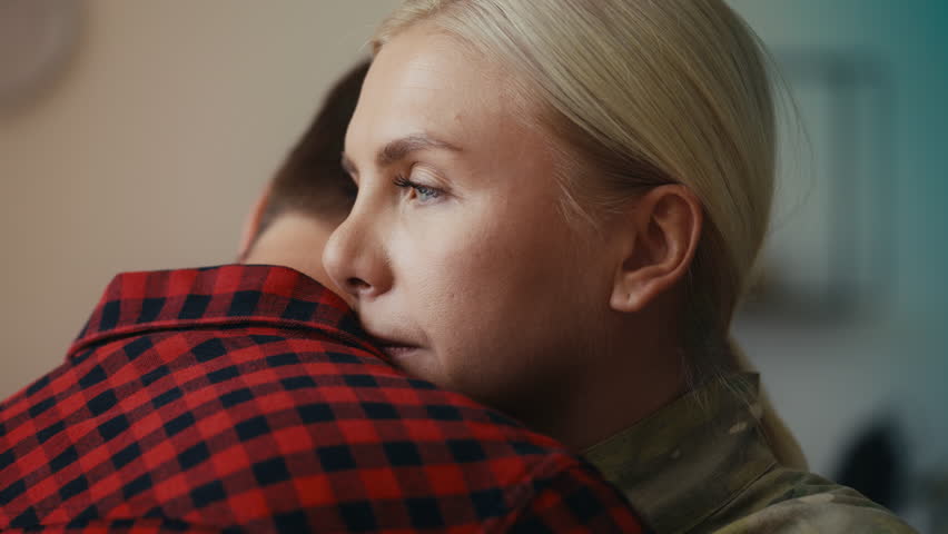 Sad military woman hugging her husband, farewell before leaving for service