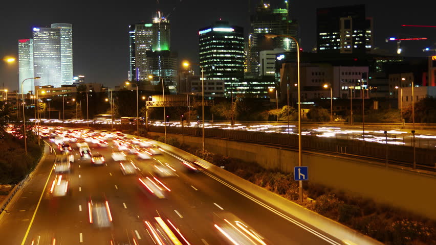 Movement of vehicles on the road in the evening in Tel - Aviv.