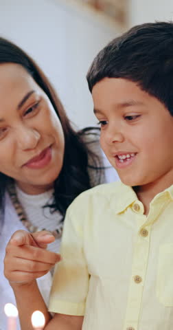 Mother, little boy and blowing candles for happy birthday, cake or celebration on special day together at home. Excited parent and child smile with applause for love, care or make a wish at house