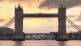 Low drone view over Thames of London double-decker red bus crossing Tower Bridge - Powered by Shutterstock - Get 15% off with code: PIKWIZARD15