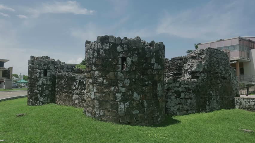 4k slow motion video of a castle like building in the entrance of the Panama Viejo historic center of Panama city. It