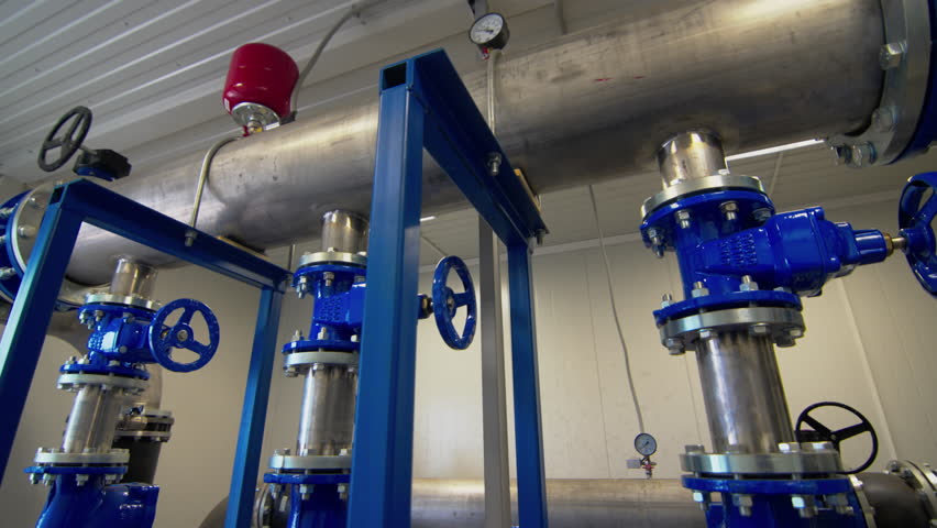 Water pumping system for tank filling with round valves for flow control. Liquid supply system to tanks in chemical plant workshop