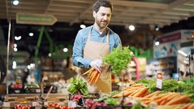 Man greengrocer, a grocery store worker, or a farmer small business owner, works in a vegetable market. Marketplace A seller employee in an apron near a counter with fresh vegetables in a supermarket - Powered by Shutterstock - Get 15% off with code: PIKWIZARD15