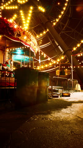 A carnival ride with bright lights illuminates the night at an abandoned amusement park, showcasing a nostalgic yet eerie scene.