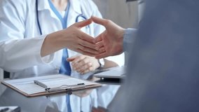 Doctor and patient handshake in clinic setting above the glass table. Medicine concept trust and agreement - Powered by Shutterstock - Get 15% off with code: PIKWIZARD15