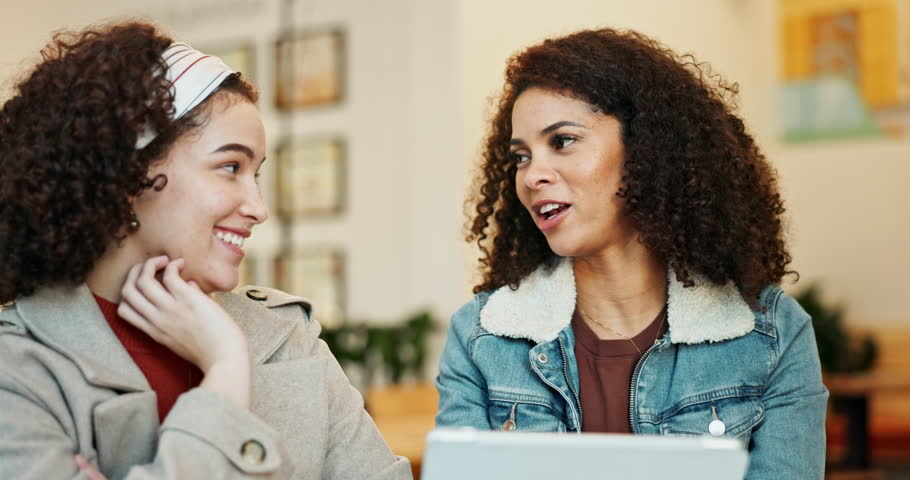 Cafe, friends and discussion with digital tablet, review menu and weekend promotion of beverages. Happy people, women and technology in restaurant for decision, choice and browse for coffee options