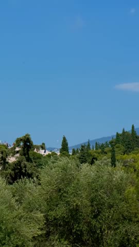 Famous greek tourist landmark - the iconic Parthenon Temple at the Acropolis of Athens as seen from Pnyx Hill, Athens, Greece. Horizontal camera pan