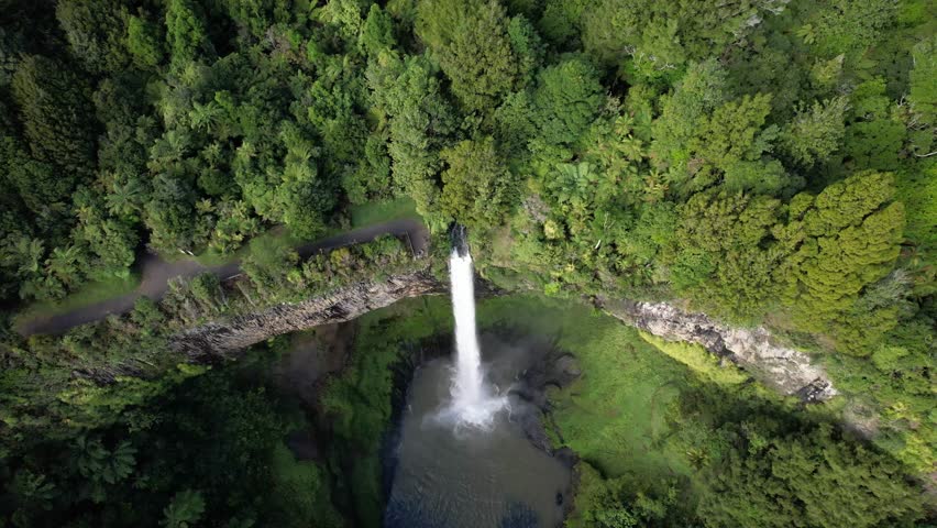 Bridal Veil Falls (Waireinga) Flowing From Steep Cliffs Near Raglan, Waikato, North Island, New Zealand. Aerial Descending Shot