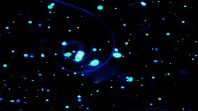 A swirling pattern of blue and green lights against a black background. Bioluminescent Plankton in the Ocean at Night - Powered by Shutterstock - Get 15% off with code: PIKWIZARD15