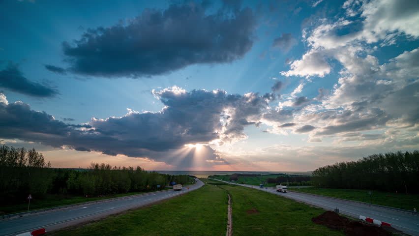 Time lapse over a major highway with an epic beautiful time lapse of clouds over that road from a bird's eye view