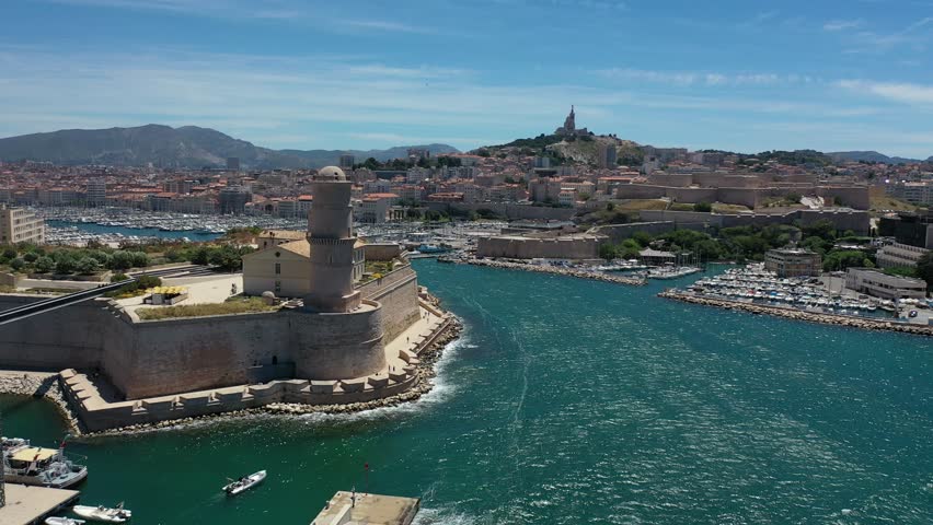 video from a drone flying over ships and ships in the marina in the center of Marseille, France on a sunny summer day
