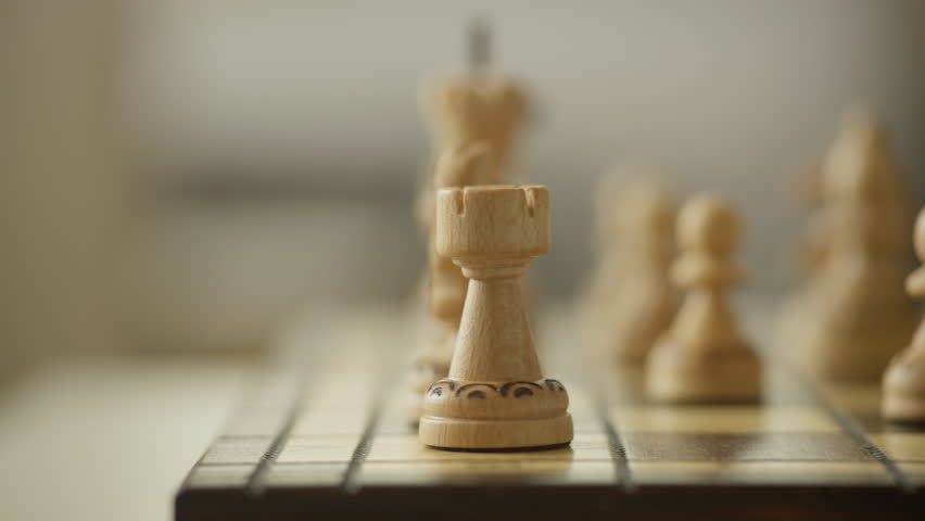 Hand Moving Chess Piece on Board