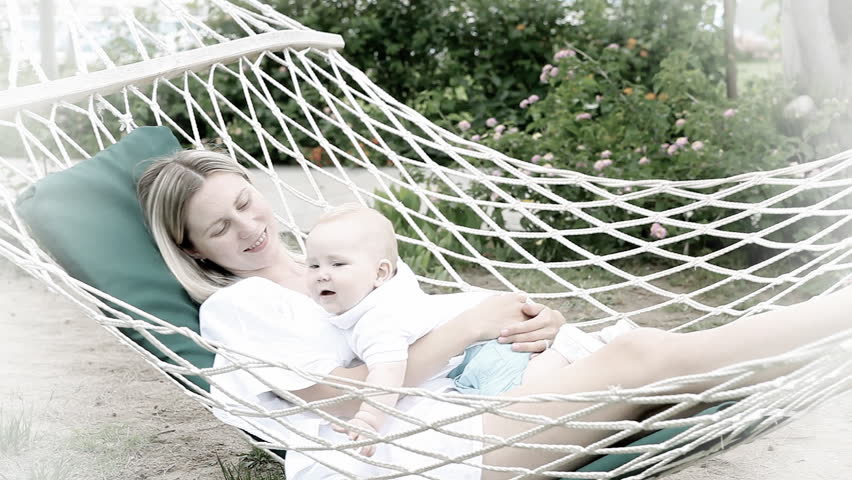 Happy baby with mother in hammock