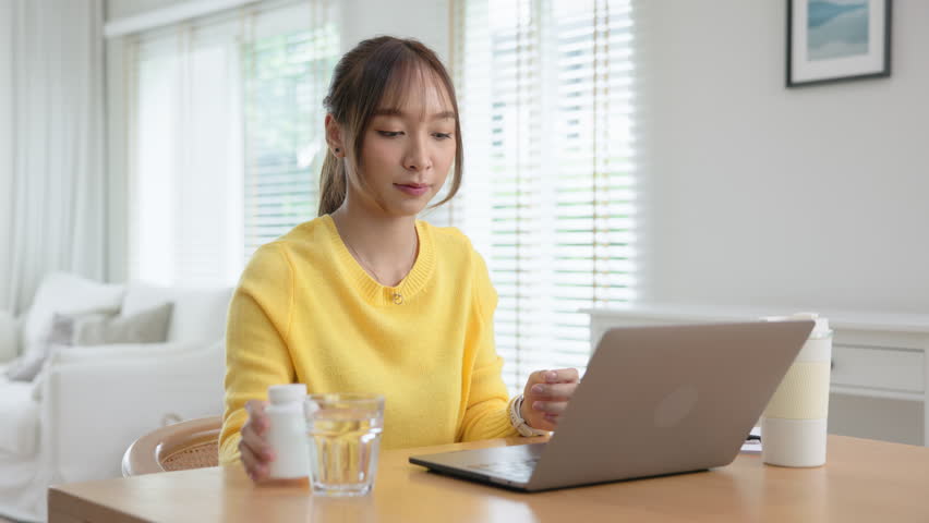 Happy fresh asia people young adult woman take skin care detox pill folic iron drinking diet zinc vit e b c d boost water for worker enjoy relax work at home desk. Herbal refresh glass immune system