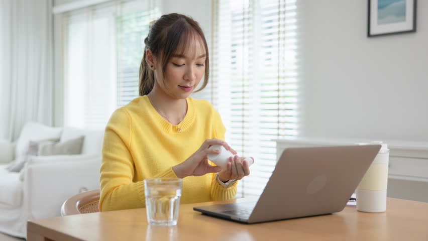 Happy fresh asia people young adult woman take skin care detox pill folic iron drinking diet zinc vit e b c d boost water for worker enjoy relax work at home desk. Herbal refresh glass immune system