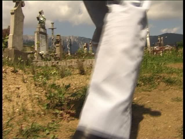 Person walking in graveyard