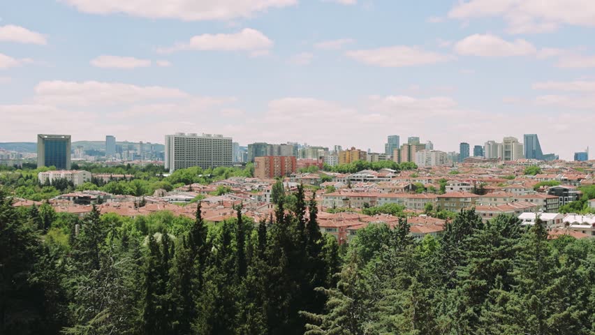 A captivating view of Ankara, Turkey, from a high vantage point. Watch as the citys skyline unfolds, with lush greenery and the blue sky providing a beautiful backdrop