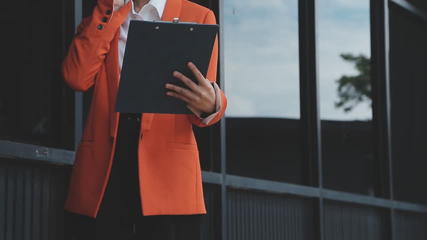 Young Asian businesswoman and businessman discuss investment project working and planning strategy on digital tablet. Business people talking together with tablet at office.