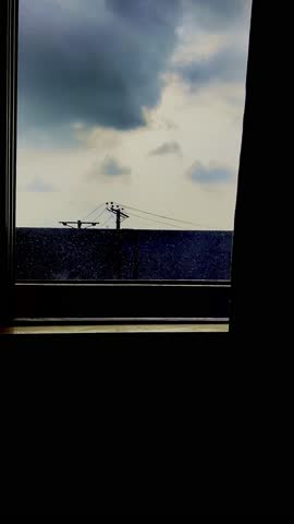 clouds and rain through rooms window