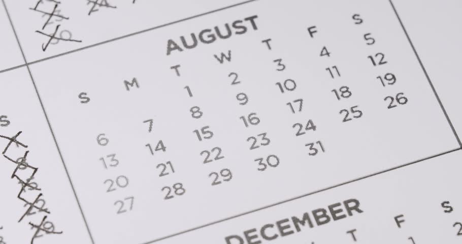 The month of August on a calendar with all of the days crossed out with a black pen. Concept for busy month, time management, or end of summer. Crossing Out Dates On Calendar