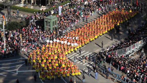 New York, NY - Circa 2011: Marching Band in Yellow Skirts turn corner as they march past an attentive crowd during the Macy's Thanksgiving day parade