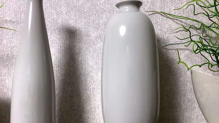 Wall clock. Vases on the shelf.