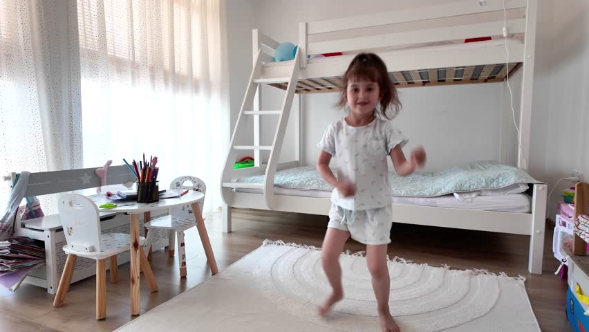 Cute little girl dancing and having fun at home