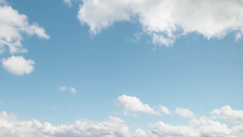 Close-up of romantic white clouds on a blue sky. Background with empty space for titles.