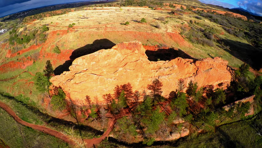 Aerial Panning Shot Of Tranquil Rock Formations On Green Landscape During Sunny Day - Colorado Springs, Colorado