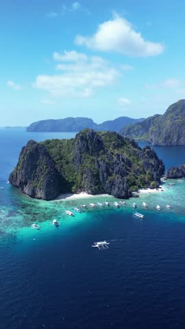 An aerial footage of the boats moored off the shore of Shimizu Island on a sunny summer day in El Nido, Palawan, Philippines