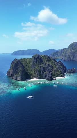 An aerial view of the boats moored off the shore of Shimizu Island on a sunny day in El Nido, Palawan, Philippines