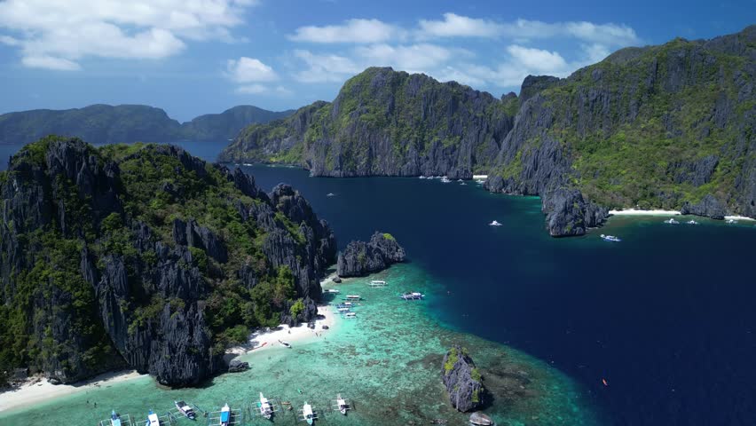 An aerial view of the boats moored off the shore of the scenic Shimizu Island on a sunny day in El Nido, Palawan, Philippines