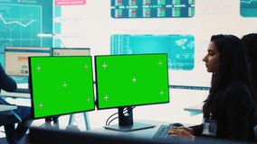 Executive officer analyzing greenscreen on monitors at his workstation, find ways of increasing organizational funds to expand the business globally. Isolated mockup screen in control room. Camera A. - Powered by Shutterstock - Get 15% off with code: PIKWIZARD15