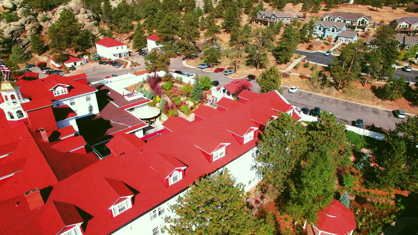 Aerial Backward Shot Of People Exploring Stanley Hotel On Sunny Day - Denver, Colorado