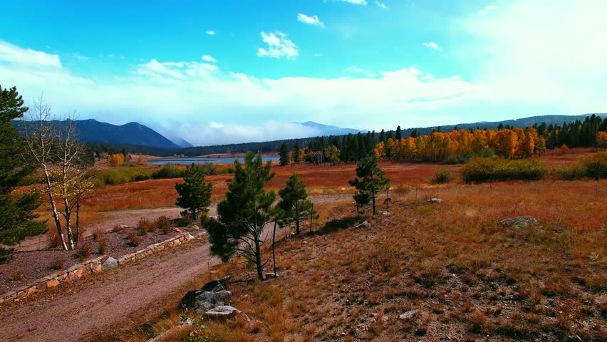 Aerial Scenic Shot Of Lake By Tranquil Mountains, Drone Flying Forward Over Landscape On Sunny Day - Denver, Colorado