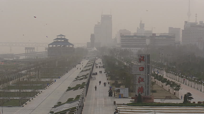 View of hazy city near riverbank