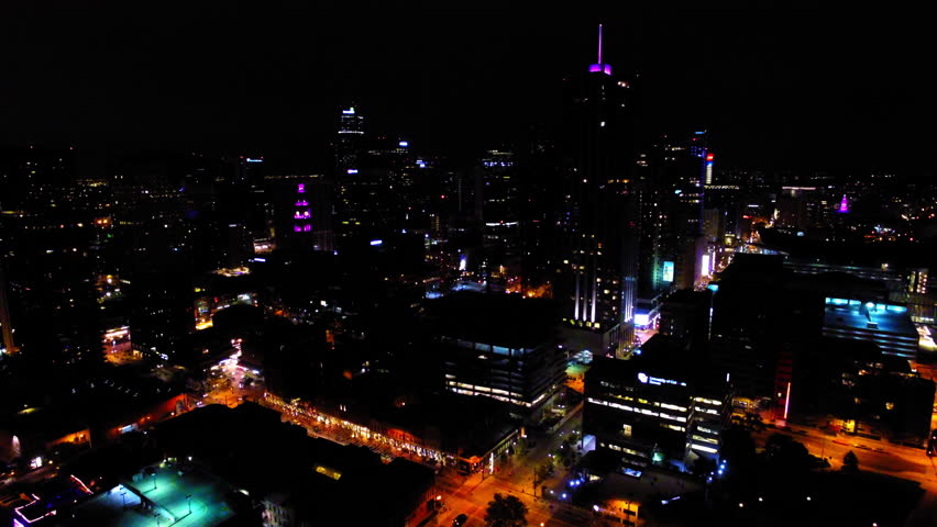 Aerial Backward Shot Of Illuminated Buildings Against Clear Sky At Night - Denver, Colorado