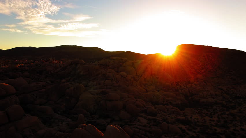 Aerial Scenic View Of Tranquil Mountains, Drone Flying Backwards Over Desert Landscape At Sunset - Joshua Tree, California