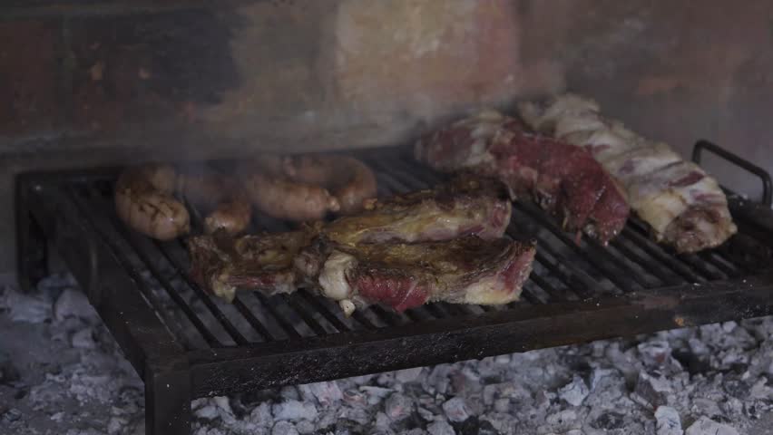 A closeup of fresh meat on the grill. Argentinean barbecue.