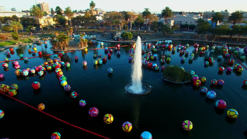 Aerial: Drone Panning Shot Of Macarthur Park In Residential City Against Clear Sky - Los Angeles, California
