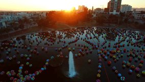 Aerial: Drone Panning Shot Of Colorful Balls Floating On Water In Macarthur Park At City During Sunset - Los Angeles, California - Powered by Shutterstock - Get 15% off with code: PIKWIZARD15