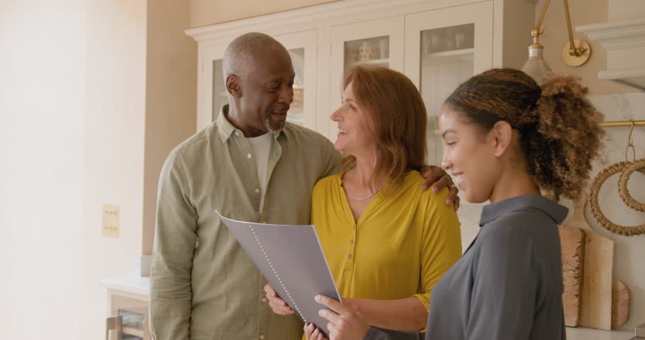 Senior Couple Looking at a Property with a Real estate agent
