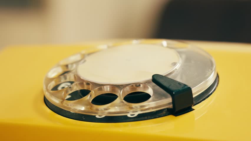 Retro vintage phone, A yellow rotary telephone is displayed on a wooden desk, adding a nostalgic touch