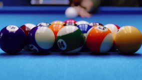 Close up behind balls. Woman breaking racked pool balls in eight-ball on billiard table. Classic american billiard game leisure activity in sport club. High quality 4k footage - Powered by Shutterstock - Get 15% off with code: PIKWIZARD15