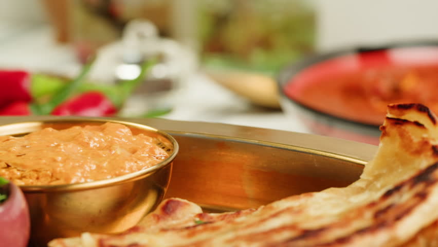 Assorted indian Sri Lankan food set on wooden background. Dishes and appetisers of indeed cuisine, rice, lentils, paneer, samosa, spices, masala. Bowls and plates with indian food top view chicken