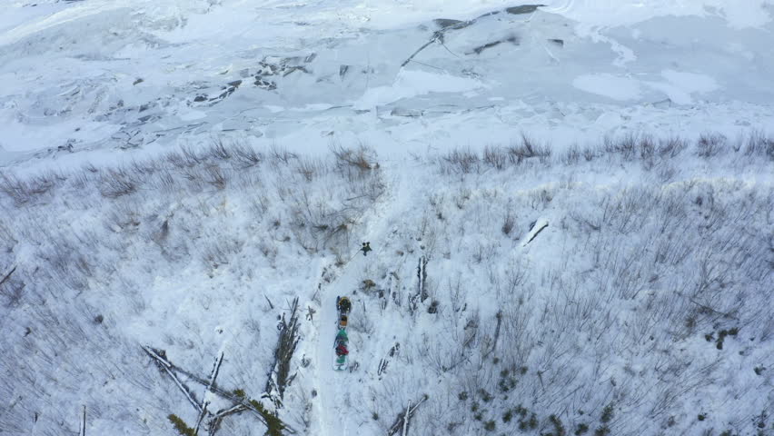 Aerial Panning Beautiful Cool Shot Of Snowy Rock Formation Against Clear Sky - Calico Bluff, Alaska