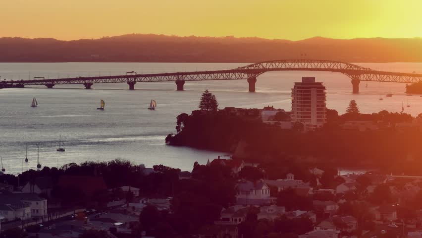 Auckland Harbour Bridge and the neighbourhood of Bayswater and Devonport at sunset, Auckland, New Zealand. 