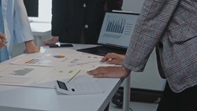 Diverse team discussing and analyzing financial charts and graphs in a professional office setting, focusing on collaboration and data analysis - Powered by Shutterstock - Get 15% off with code: PIKWIZARD15